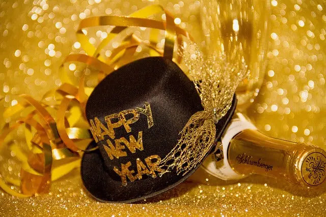 Festive New Year celebration featuring a black hat with 'Happy New Year'