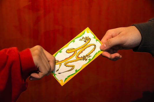 a person handing another person a piece of paper