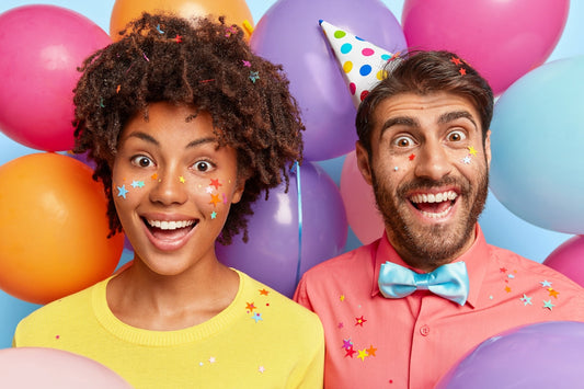 A man and a woman standing in front of balloons