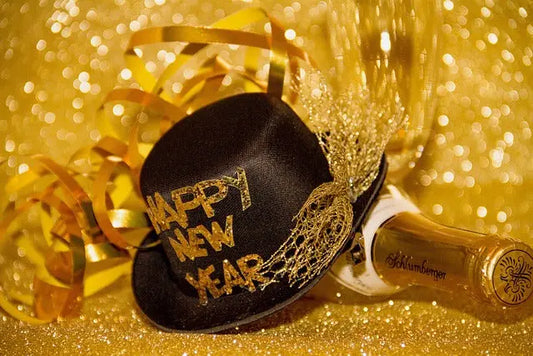 Festive New Year celebration featuring a black hat with 'Happy New Year'