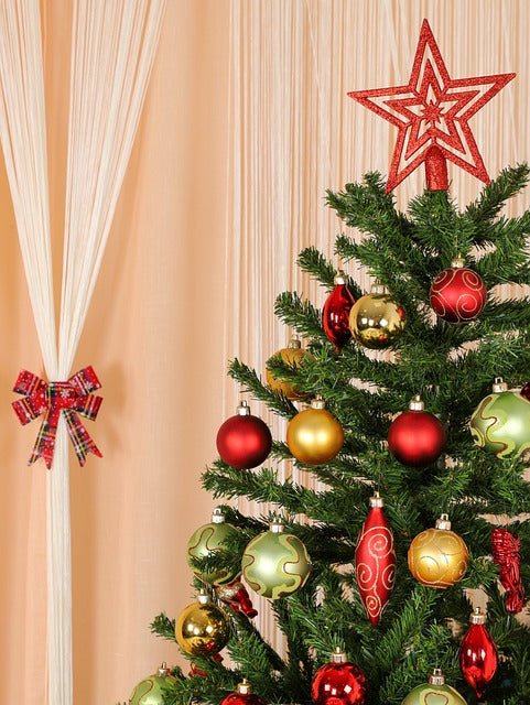  A family playing Christmas trivia around a beautifully decorated living room.