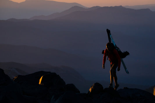 2 women standing on rock formation during daytime