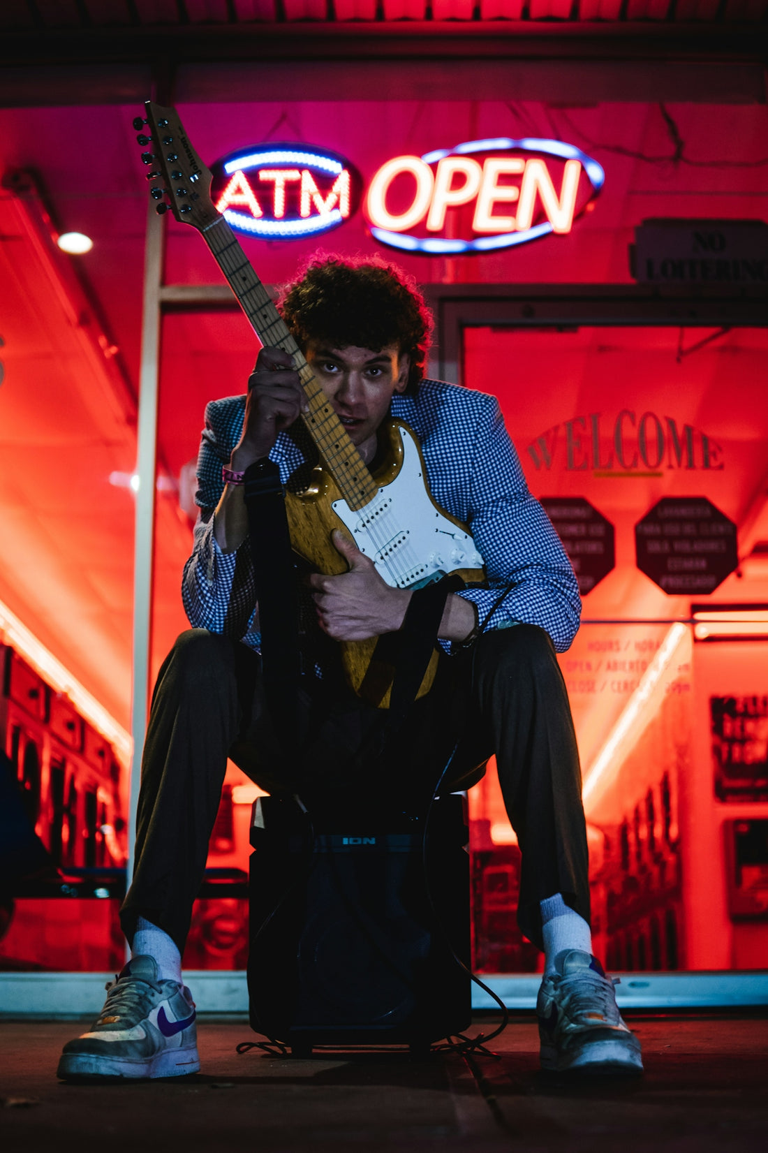 a man sitting on a chair holding a guitar
