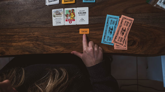 a person sitting at a table with some cards on it