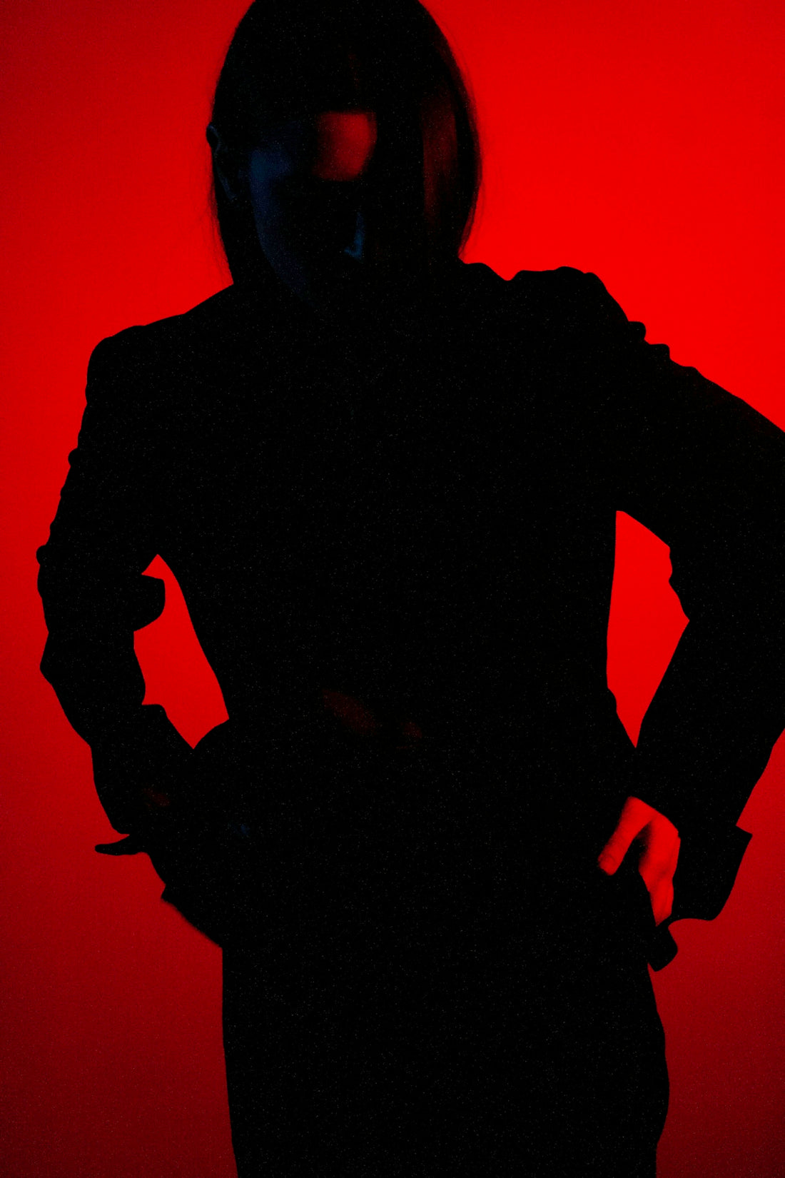 a silhouette of a person with their hands on their hips