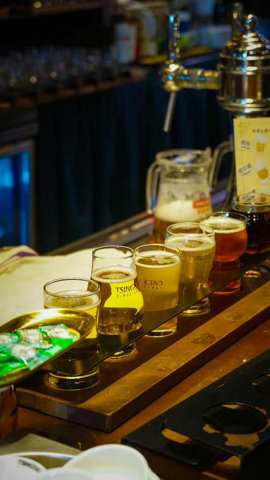 a row of beer glasses sitting on top of a counter