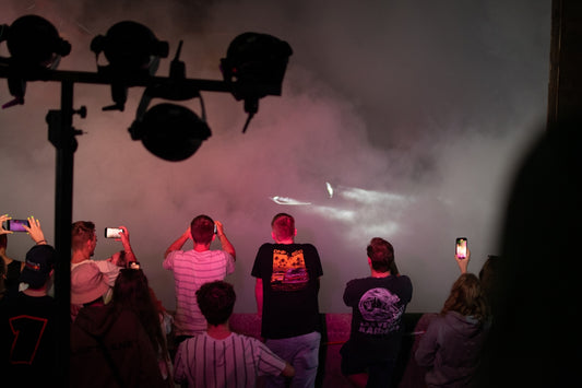 A crowd of people standing around a street light