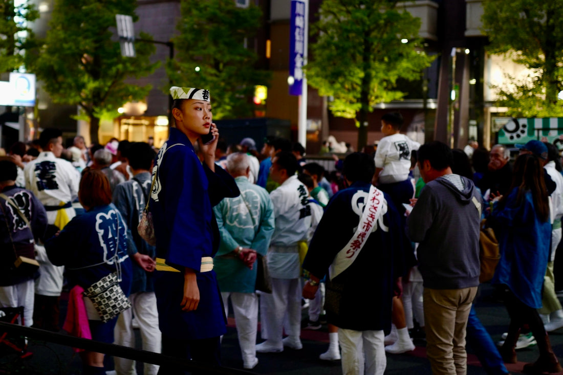 A crowd of people standing around each other