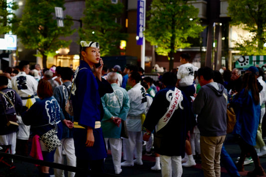 A crowd of people standing around each other