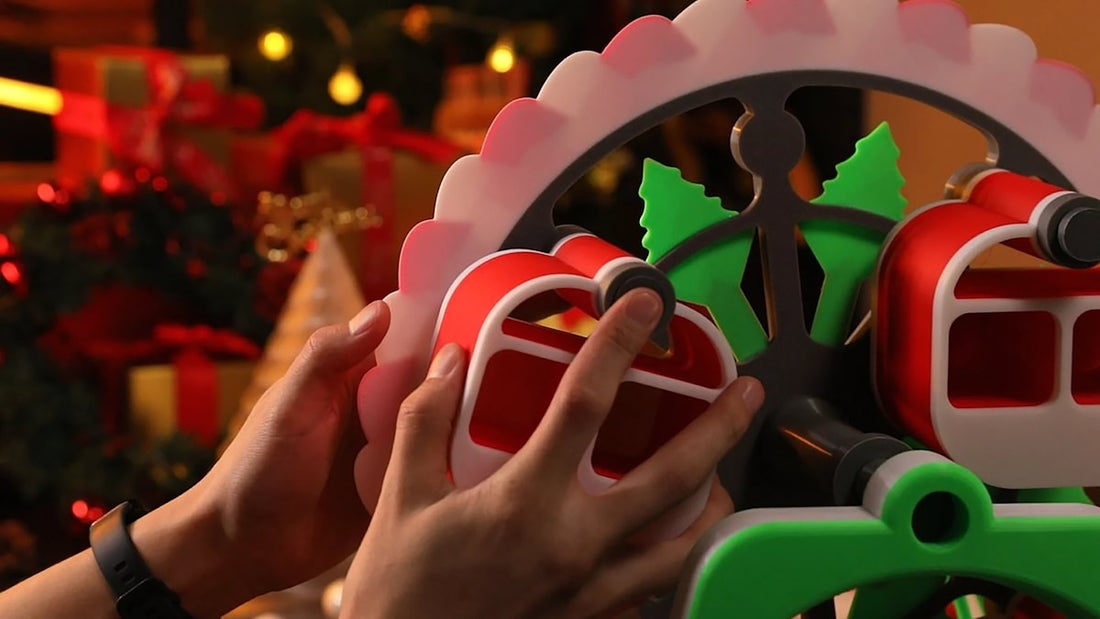 A person holding a christmas decoration in front of a christmas tree