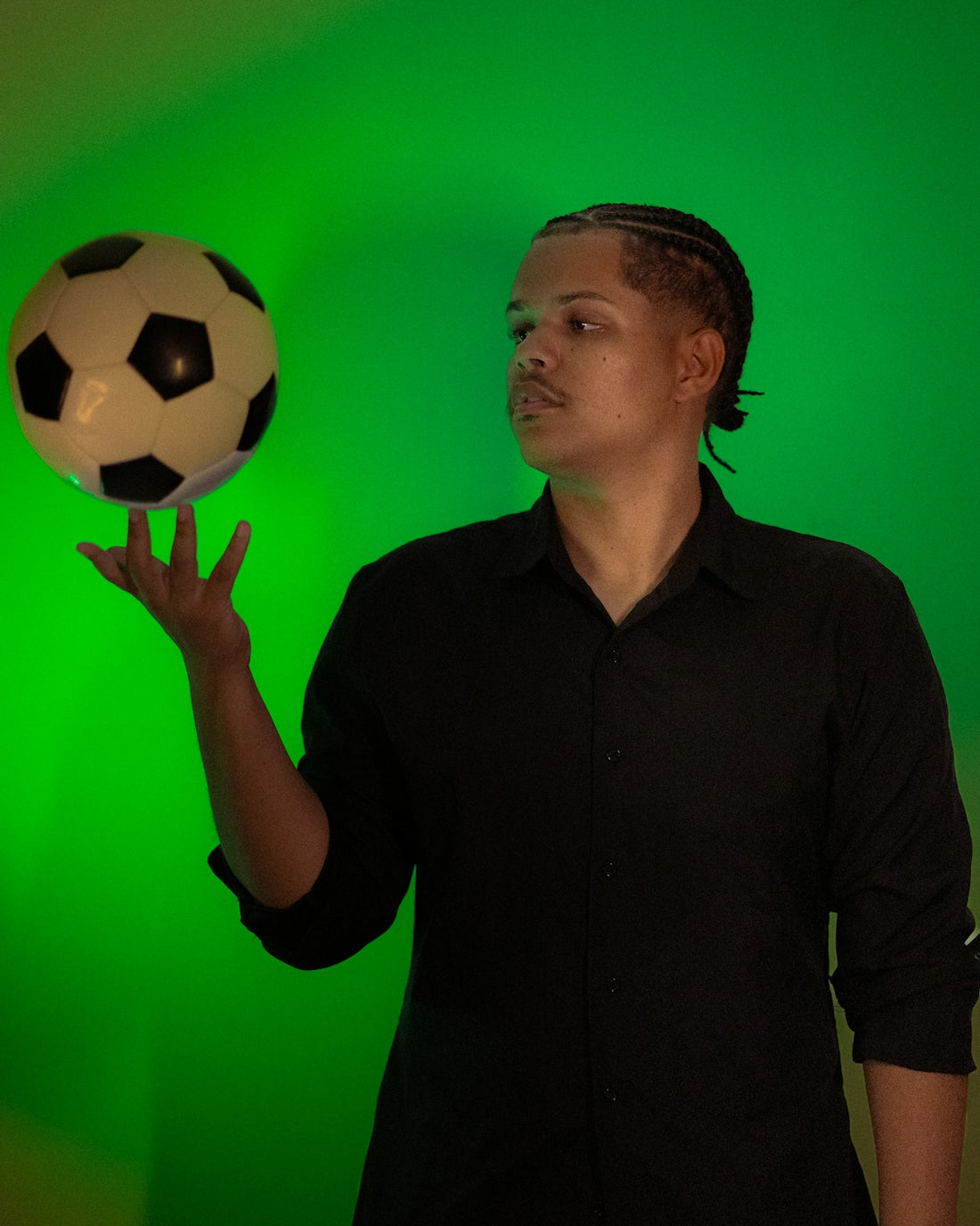 Man balancing soccer ball on his finger