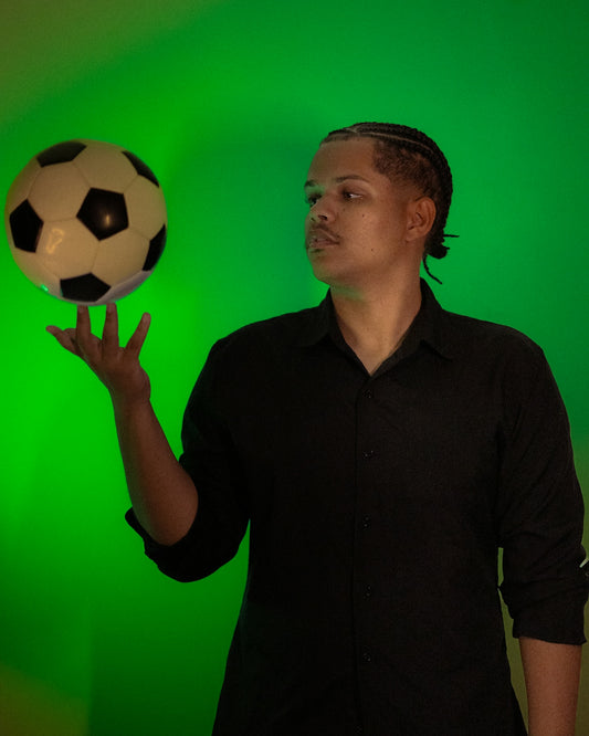 Man balancing soccer ball on his finger