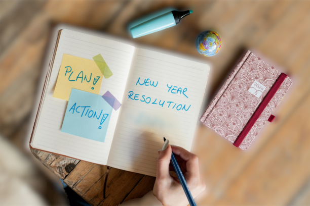 An open journal with 'New Year Resolution showing goal-setting and planning for the year.ritten